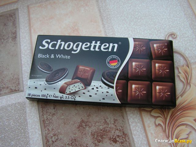 Шоколад молочный Schogetten "Black & White" с начинкой "ванильный крем" с кусочками печенья с какао